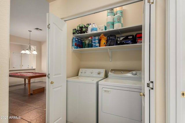 clothes washing area featuring independent washer and dryer and light tile patterned flooring