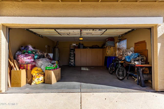 garage featuring water heater and a garage door opener