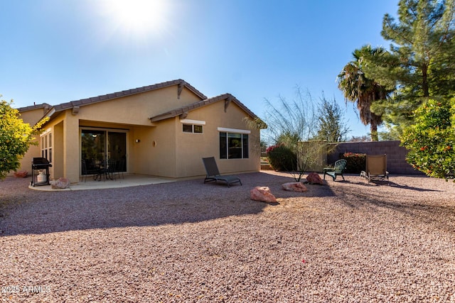 back of property with a patio