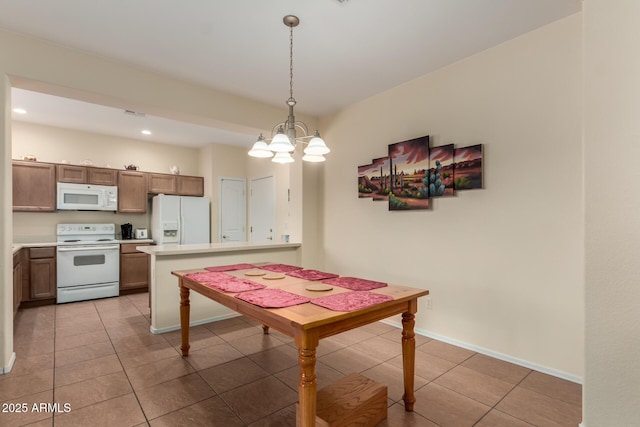 tiled dining area with a notable chandelier