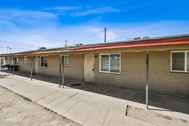 2237 E Taylor St, Phoenix, AZ 85006 - view of property exterior featuring a patio area and brick siding