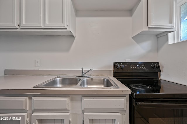 2237 E Taylor St, Phoenix, AZ 85006 - kitchen with black electric range oven, white cabinets, and light countertops