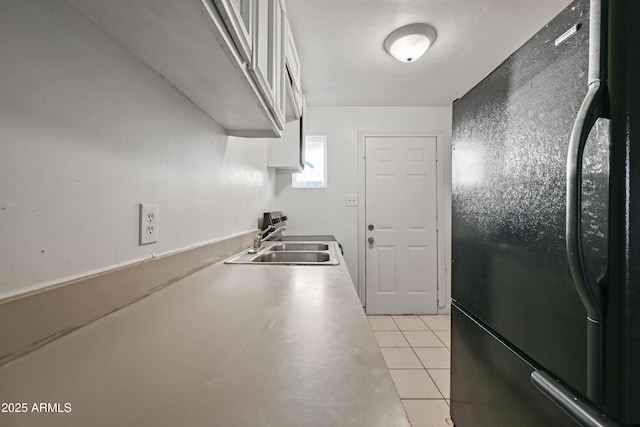 2237 E Taylor St, Phoenix, AZ 85006 - kitchen featuring freestanding refrigerator, light tile patterned floors, white cabinetry, and light countertops