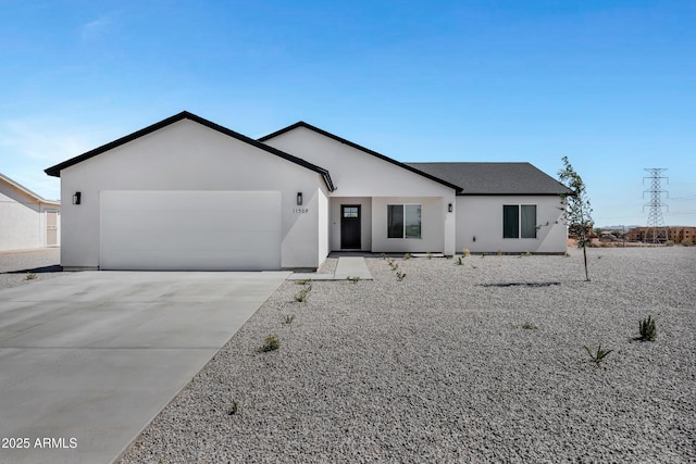 11509 W Langford Ct, Youngtown, AZ 85363 - ranch-style house featuring a garage, driveway, and stucco siding