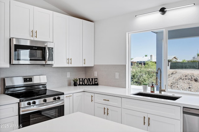 11509 W Langford Ct, Youngtown, AZ 85363 - kitchen featuring appliances with stainless steel finishes, a sink, light countertops, white cabinetry, and tasteful backsplash