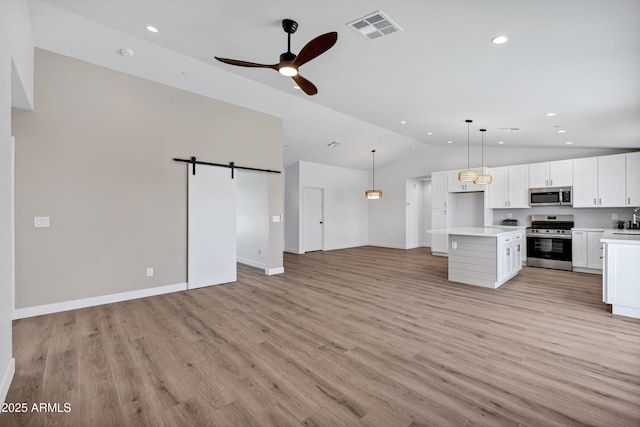 11509 W Langford Ct, Youngtown, AZ 85363 - kitchen featuring stainless steel appliances, lofted ceiling, open floor plan, light countertops, and recessed lighting