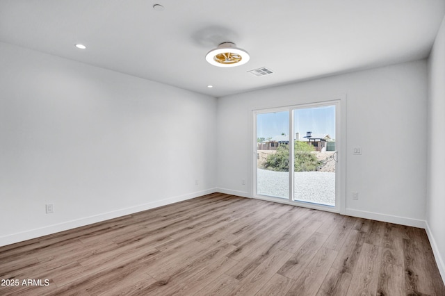 11509 W Langford Ct, Youngtown, AZ 85363 - empty room with wood finished floors, baseboards, and recessed lighting