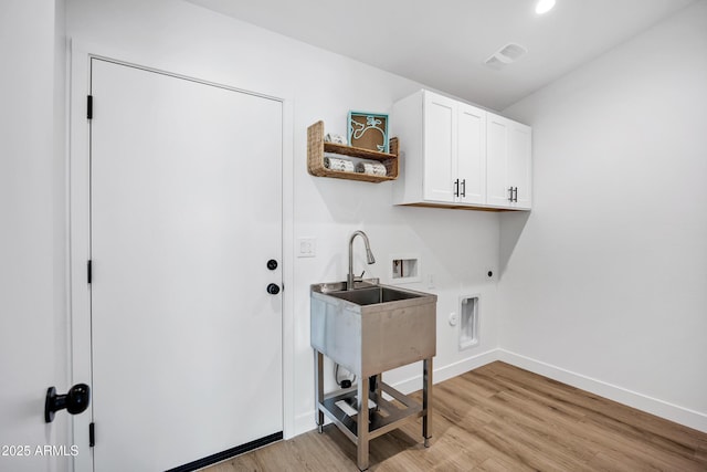 11509 W Langford Ct, Youngtown, AZ 85363 - laundry room featuring cabinet space, hookup for an electric dryer, hookup for a washing machine, and light wood finished floors