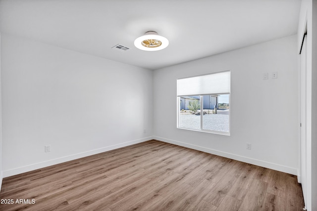 11509 W Langford Ct, Youngtown, AZ 85363 - spare room featuring wood finished floors and baseboards