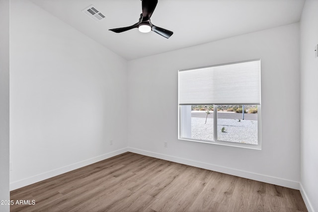 11509 W Langford Ct, Youngtown, AZ 85363 - unfurnished room with wood finished floors, baseboards, ceiling fan, and lofted ceiling
