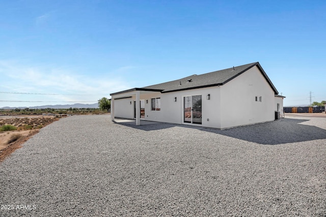 11509 W Langford Ct, Youngtown, AZ 85363 - rear view of property featuring stucco siding and a mountain view