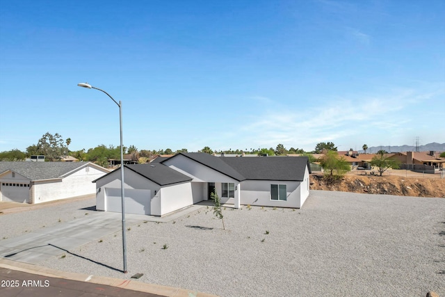 11509 W Langford Ct, Youngtown, AZ 85363 - view of front of house with driveway, a garage, and a residential view