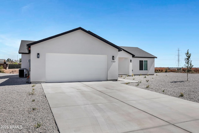 11509 W Langford Ct, Youngtown, AZ 85363 - ranch-style home with an attached garage, central air condition unit, stucco siding, and driveway