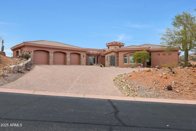 mediterranean / spanish home with a garage