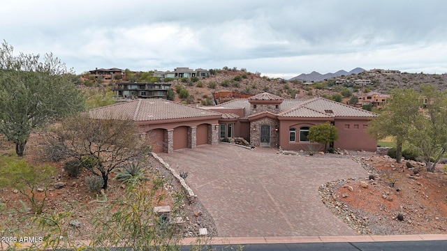 mediterranean / spanish home with a garage