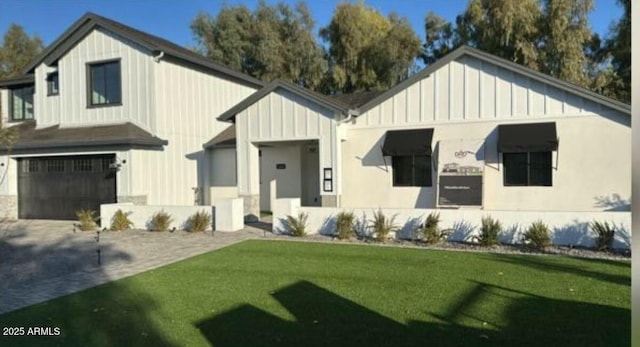 modern farmhouse featuring a garage and a front lawn