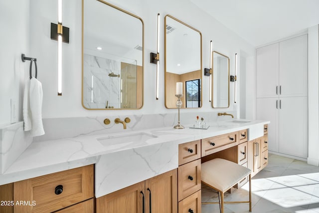 bathroom featuring walk in shower and vanity