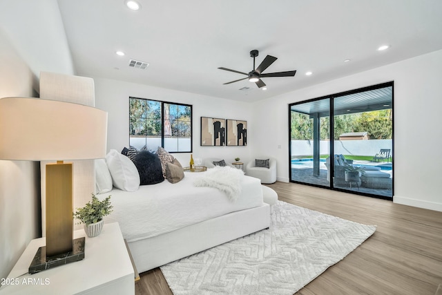 bedroom featuring hardwood / wood-style flooring, access to exterior, and ceiling fan