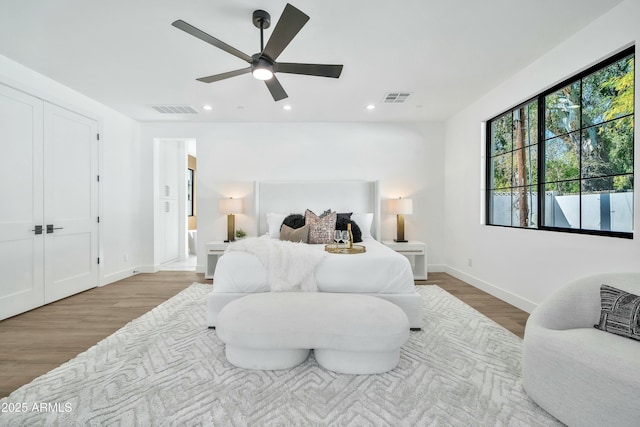 bedroom featuring light hardwood / wood-style flooring and ceiling fan