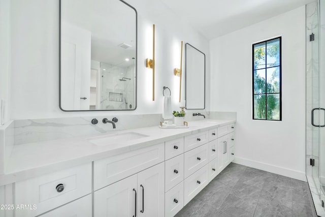 bathroom with vanity and a shower with shower door