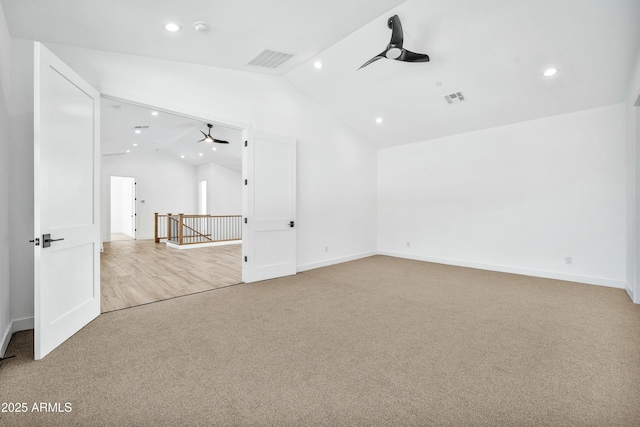 carpeted empty room featuring ceiling fan and lofted ceiling