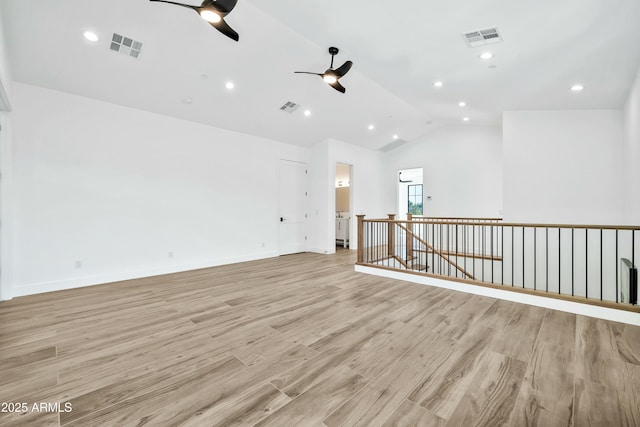 unfurnished room featuring vaulted ceiling, ceiling fan, and light hardwood / wood-style floors