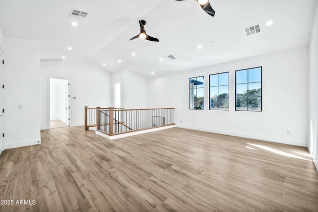 spare room with ceiling fan, lofted ceiling, and light hardwood / wood-style floors