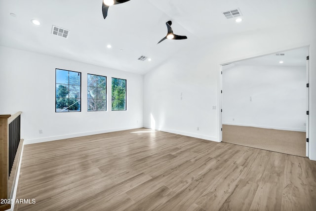 unfurnished living room with ceiling fan, lofted ceiling, and light hardwood / wood-style floors