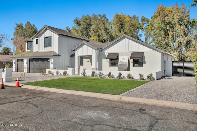 modern farmhouse style home with a garage and a front lawn