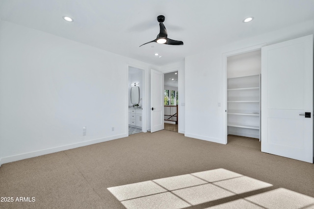 unfurnished bedroom with carpet flooring, connected bathroom, ceiling fan, and a closet