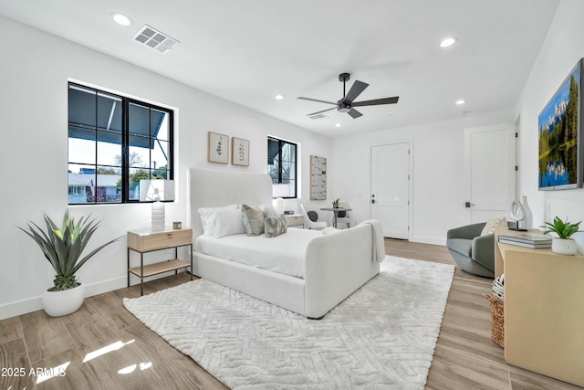 bedroom featuring multiple windows, ceiling fan, and light hardwood / wood-style floors