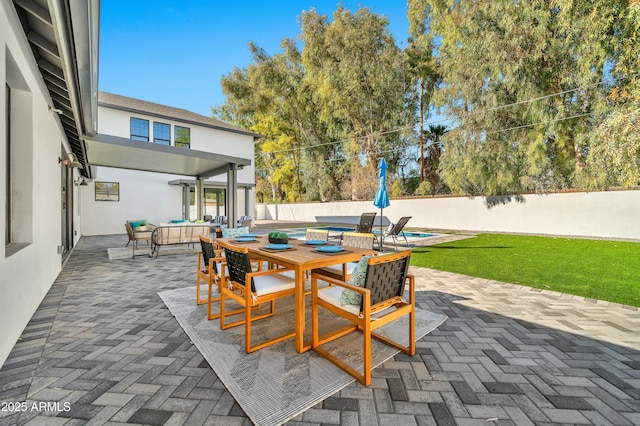 view of patio / terrace with a fenced in pool and outdoor lounge area