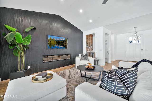 living room with hardwood / wood-style floors and vaulted ceiling