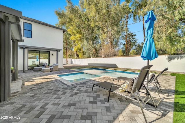 view of pool with an in ground hot tub and a patio