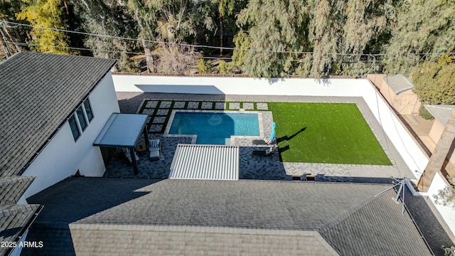 view of swimming pool with a yard and a patio