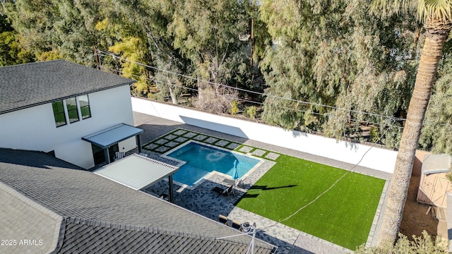 view of pool with a yard and a patio area