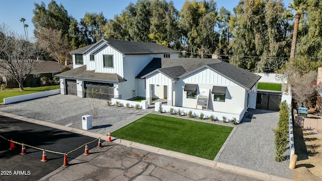 modern inspired farmhouse featuring a garage and a front yard