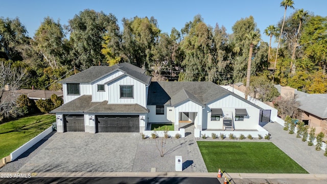 view of front of house with a garage and a front lawn