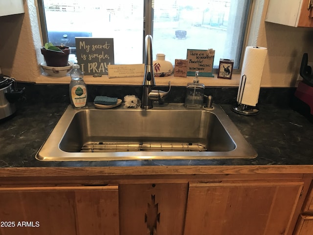 39281 Ave 61 Unit 1/2, Salome, AZ 85348 - kitchen view of a sink, brown cabinets, and dark countertops