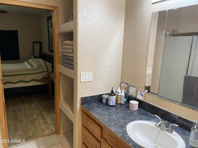 39281 Ave 61 Unit 1/2, Salome, AZ 85348 - full bathroom with ensuite bathroom, a textured wall, vanity, and tile patterned floors
