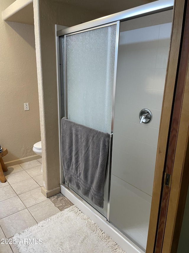 39281 Ave 61 Unit 1/2, Salome, AZ 85348 - bathroom with a stall shower, toilet, tile patterned flooring, and a textured wall