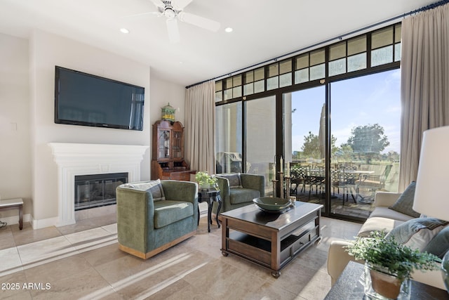 living room featuring ceiling fan, light tile patterned floors, and floor to ceiling windows