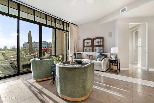 living room featuring ceiling fan, a wealth of natural light, and floor to ceiling windows