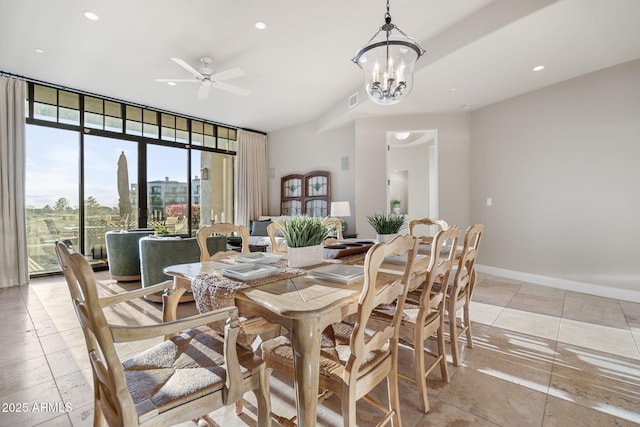 dining area featuring ceiling fan with notable chandelier and floor to ceiling windows