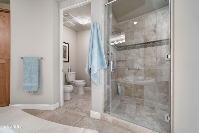 bathroom with toilet, tile patterned flooring, a bidet, and a shower with door