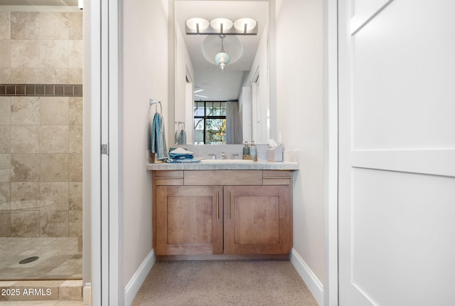 bathroom with vanity and a tile shower