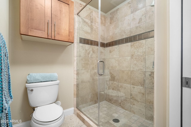 bathroom featuring toilet and a shower with door