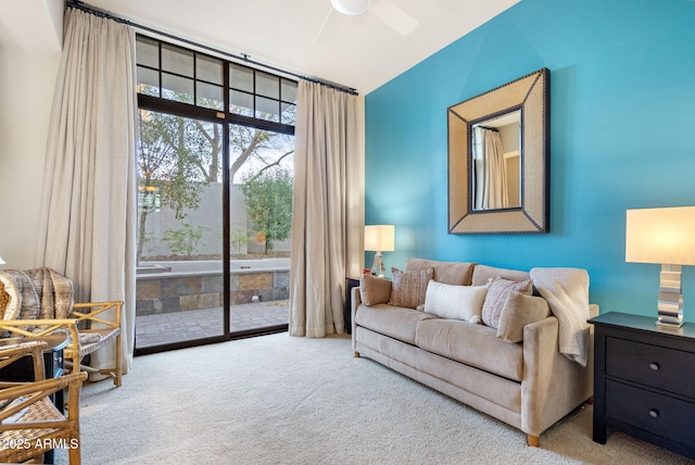 living room with carpet floors, ceiling fan, and vaulted ceiling