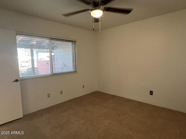 tiled empty room with ceiling fan