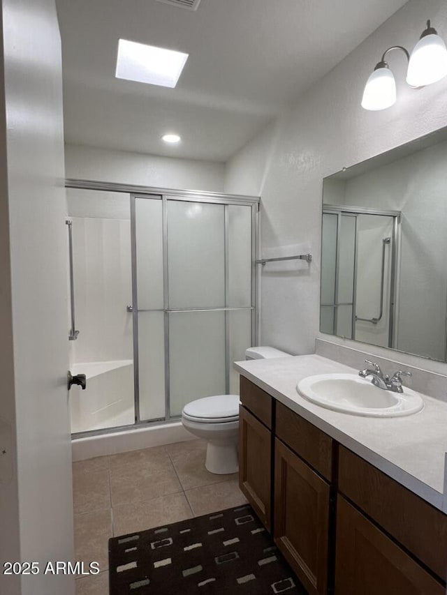 full bathroom featuring tile patterned floors, toilet, a shower stall, and vanity